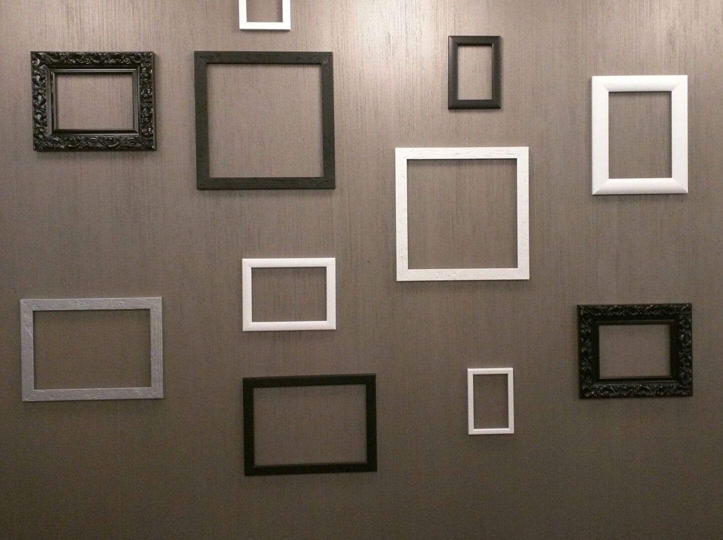 Empty picture frames mounted on a wooden wall